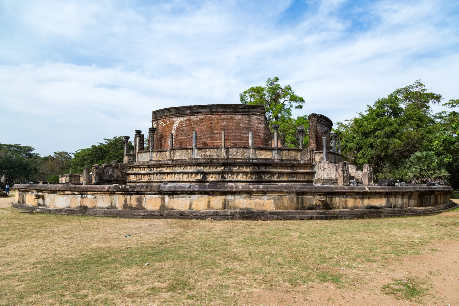 Ancient Vatadage temple with a Buddha statue and carved stone staircase in Polonnaruwa, Sri Lanka